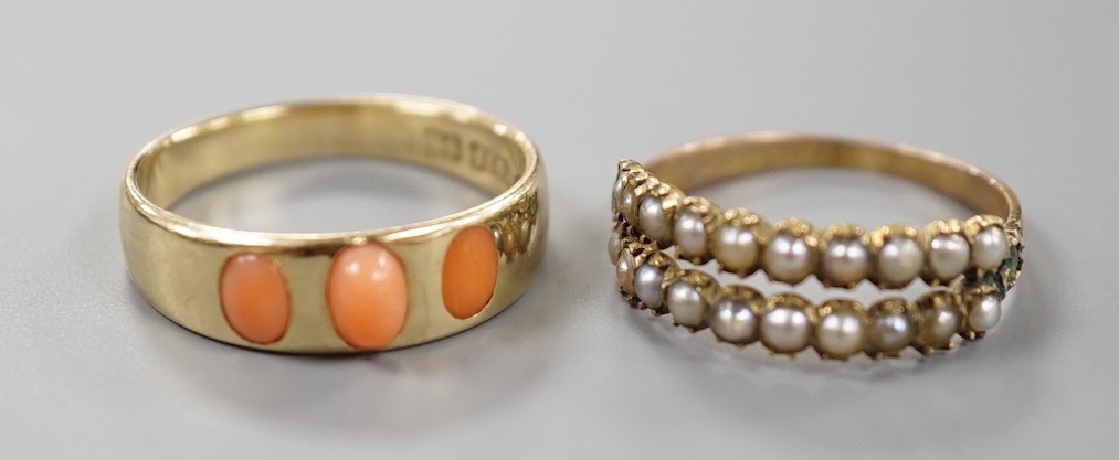 A late Victorian 15ct gold and three stone split coral set ring, size O, gross 3.3 grams and a similar yellow meta seed pearl and garnet set half hoop ring, size N, gross 1.4 grams.